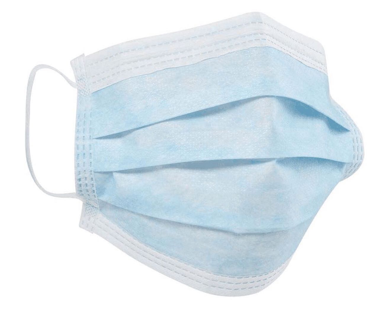 Masque visage Un masque chirurgical à usage unique déplié en tissu bleu