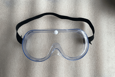 goggle-51-klein Un masque chirurgical à usage unique déplié en tissu bleu